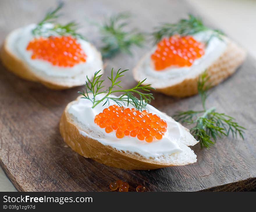 Bread with fresh cream cheese and red caviar. Bread with fresh cream cheese and red caviar