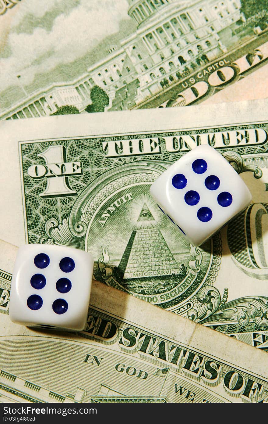 Dice on the banknotes of dollars kicking back shadow. Dice on the banknotes of dollars kicking back shadow