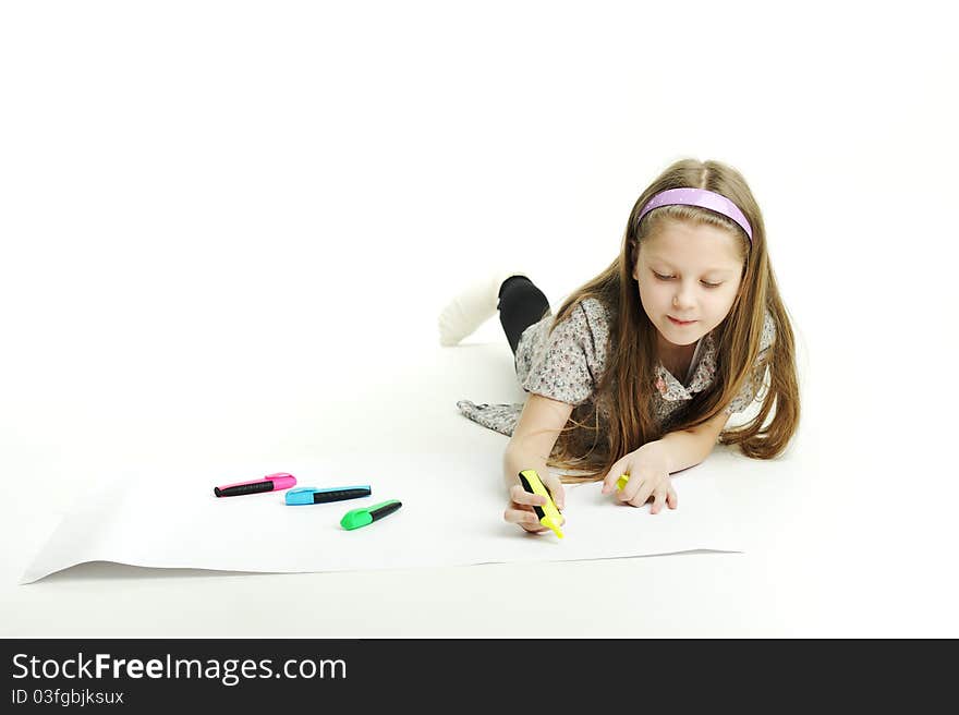 An image of a little girl drawing a picture. An image of a little girl drawing a picture