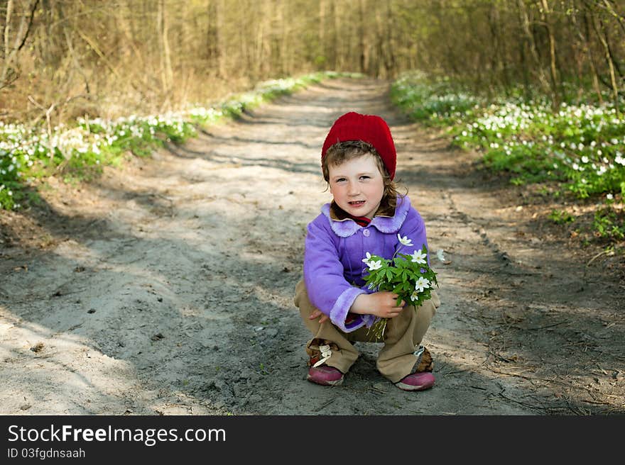 An image of a little girl in the forest