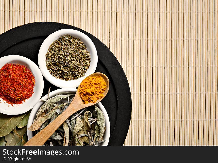 Different spices on bamboo table