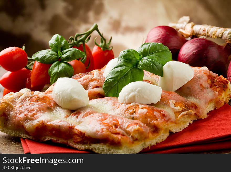 Delicious slice of pizza with buffalo mozzarella on wooden table