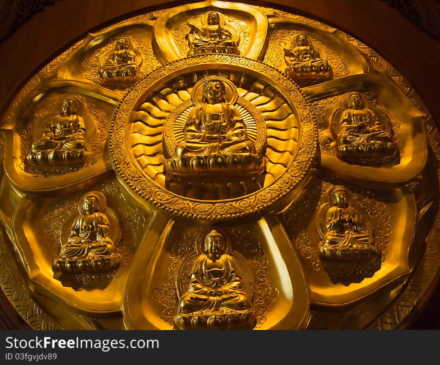 Buddha on lotus carved wood with gold paint over