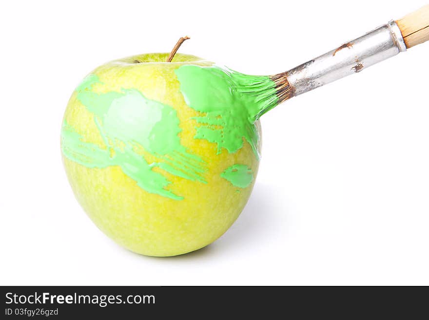 Bright green apple with brush and a paint on white. Bright green apple with brush and a paint on white