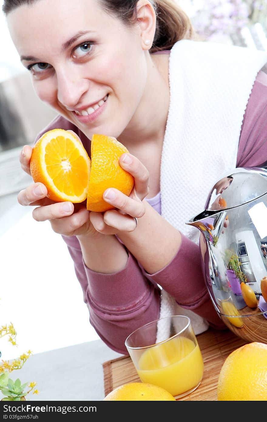 Girl in the kitchen, preparation squeezed oranges. Girl in the kitchen, preparation squeezed oranges