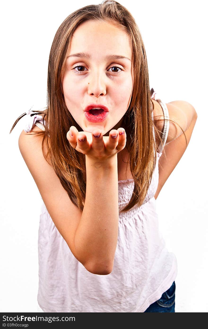 Portrait of cute young teenage girl giving a hand kiss