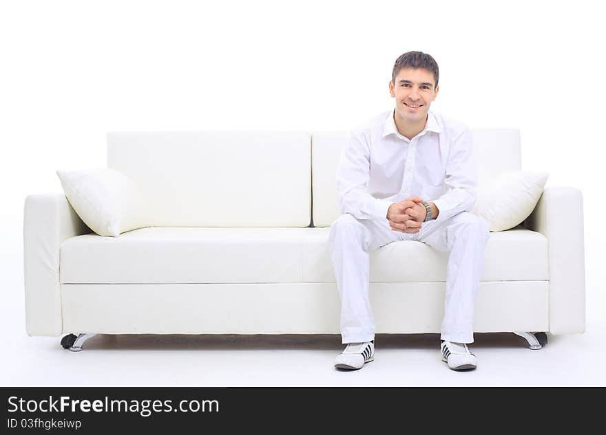 Portrait of the young man in white on sofa