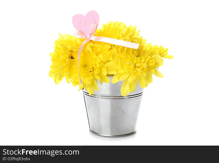 Yellow chrysanthemums in a bucket with chrysanthemums next with the text I love you and a red heart. Isolated. Yellow chrysanthemums in a bucket with chrysanthemums next with the text I love you and a red heart. Isolated