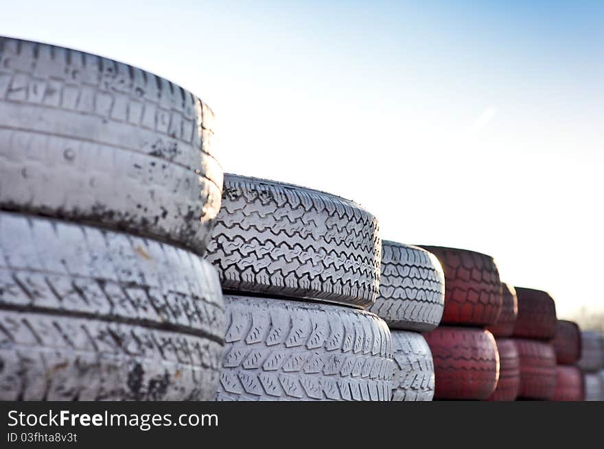 Close up of racetrack fence of red and white old tires