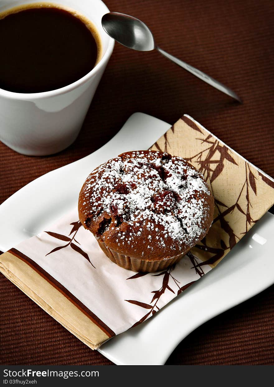 Chocolate cherry muffin with coffee - breakfast concept