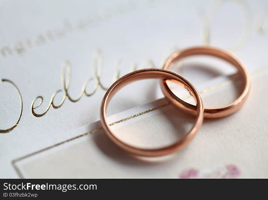 Classic golden rings on the silver wedding card