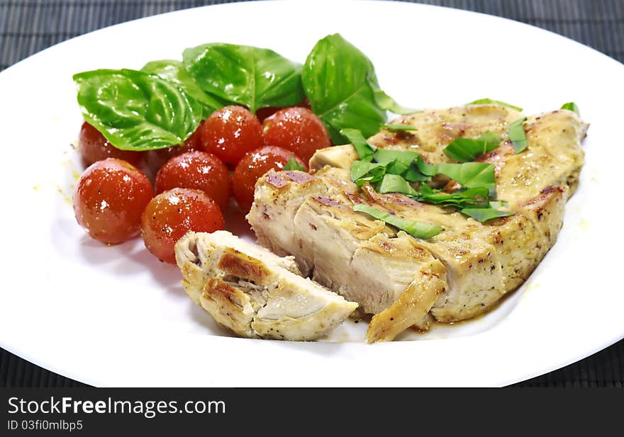 A chicken steak with a tomato salad