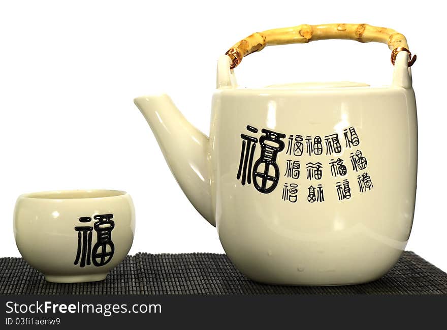 A japanese tea pot and tea cup