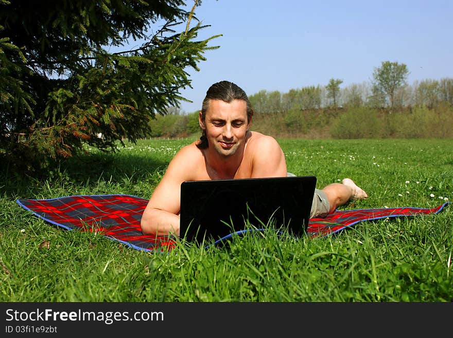 Man working with laptop outside. Man working with laptop outside