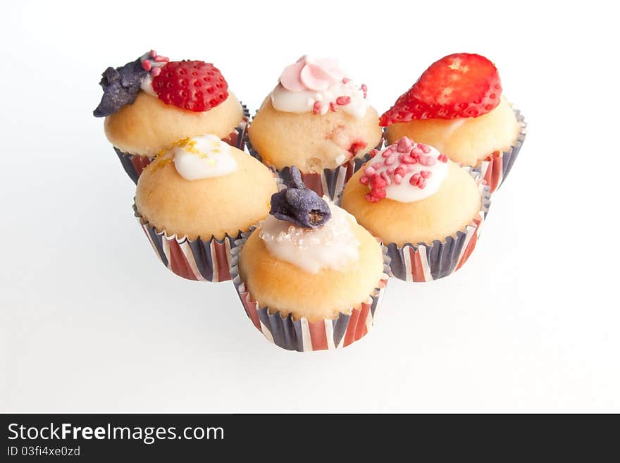 A selection of red, white & blue mini muffins in union jack paper cases. A selection of red, white & blue mini muffins in union jack paper cases