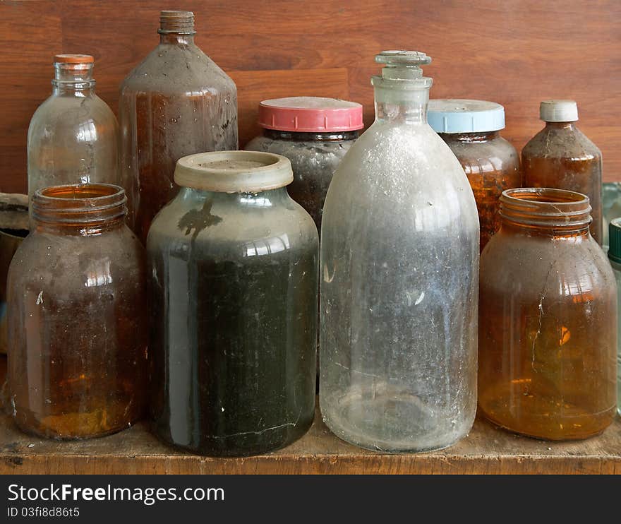 Old dusty glass bottles and jars