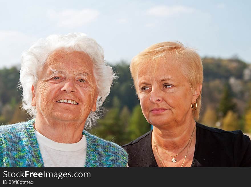 Portrait of mother and daughter taken in the exterior.