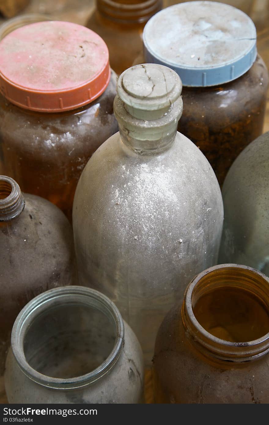 Old dusty glass bottles and jars