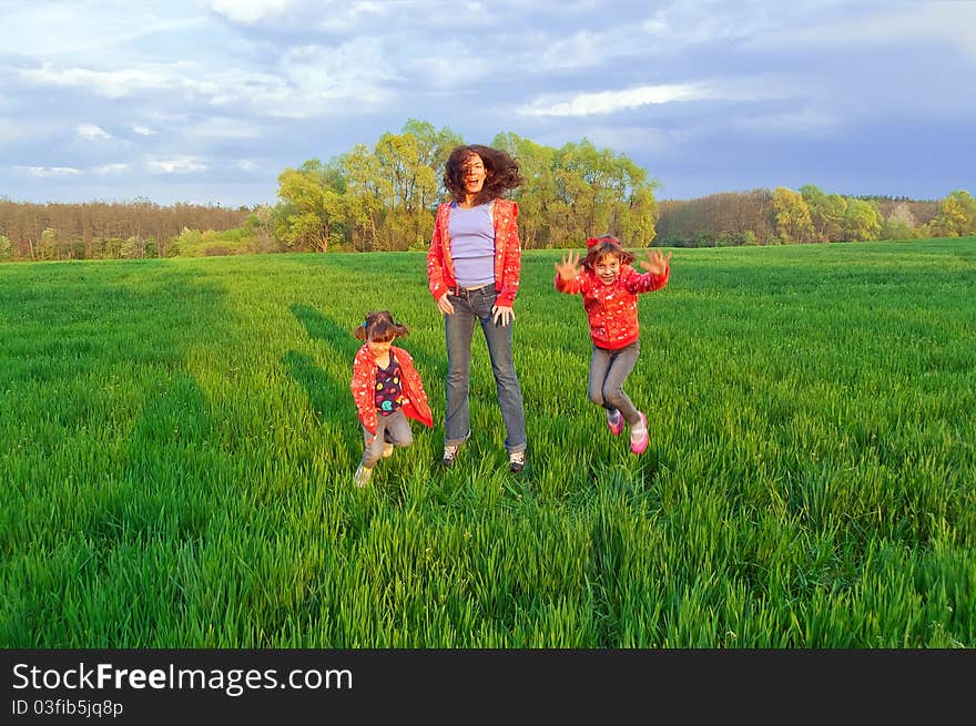 Happy mother with two kids on green field. Happy mother with two kids on green field