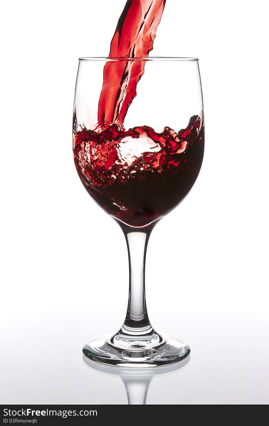 Pouring Red Wine with reflection