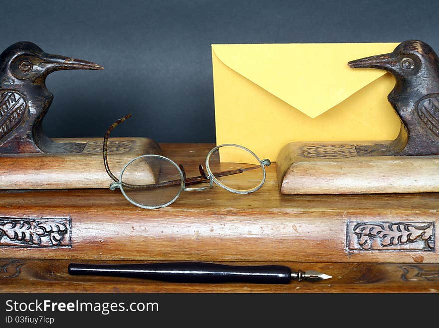 Nice old vintage wooden desk set and envelope on dark background. Nice old vintage wooden desk set and envelope on dark background