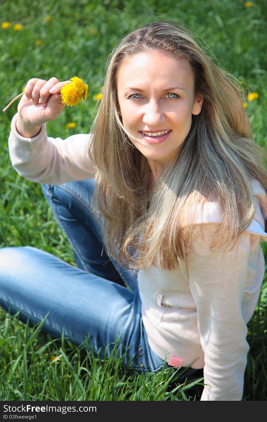 Young beautiful woman in spring field. Young beautiful woman in spring field