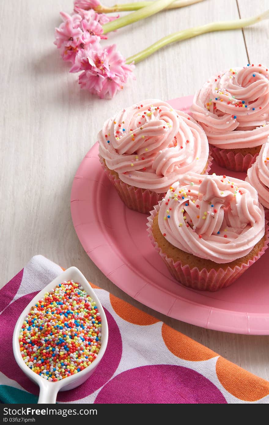 Delicious sweet cupcakes with ping topping. Delicious sweet cupcakes with ping topping