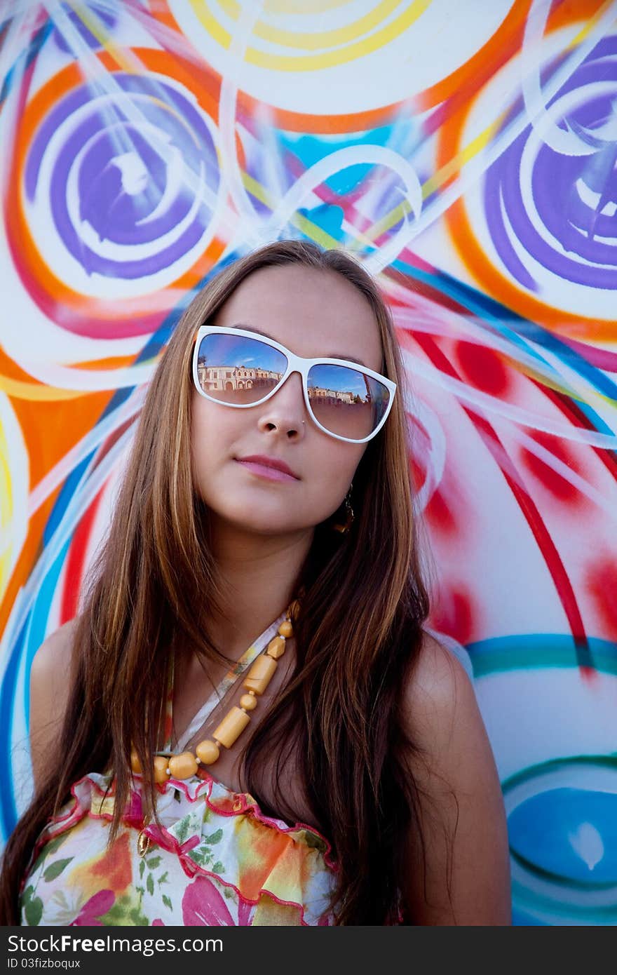 Woman In Glass Stand Near Urban Graffiti Wall