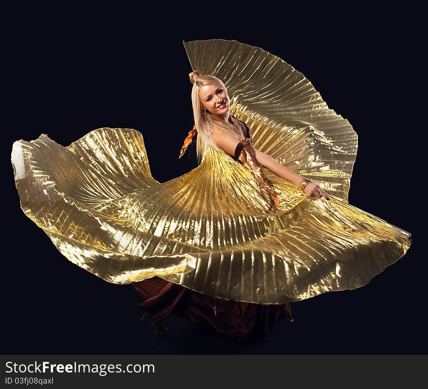 Beauty blond girl dance with flying gold wing - oriental costume. Beauty blond girl dance with flying gold wing - oriental costume