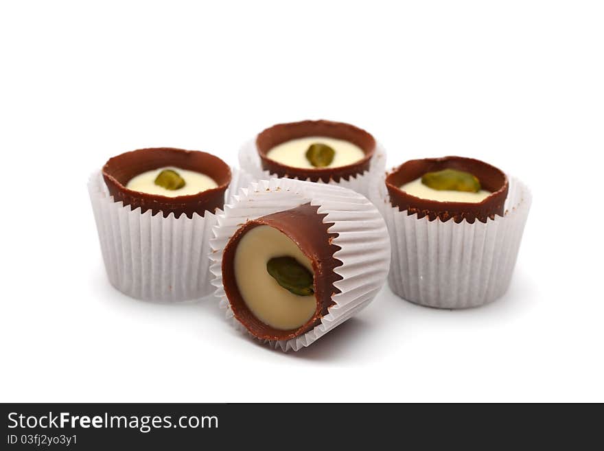 Mixed Chocolates heap against a white background ( candy basket ). Mixed Chocolates heap against a white background ( candy basket )