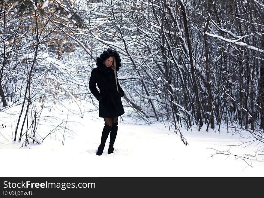 She is making a posel in a winter forest