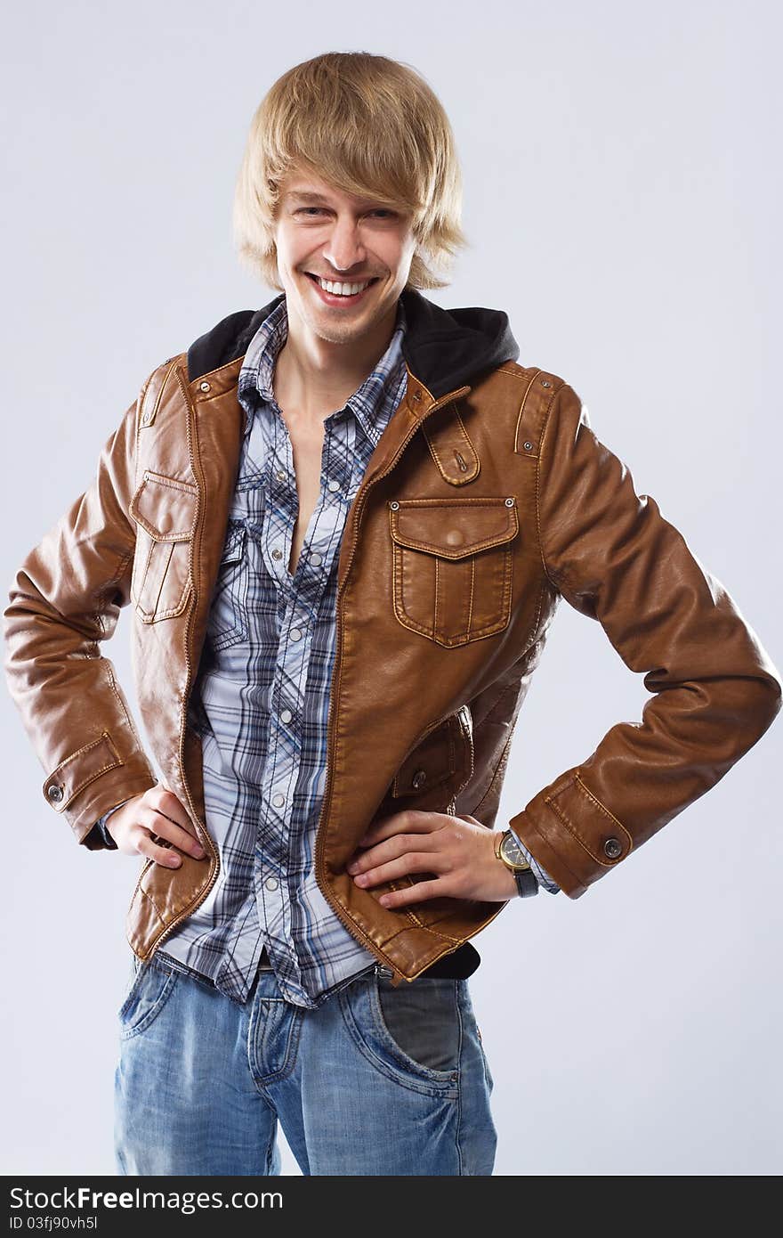 Handsome young man in leather jacket, studio portrait