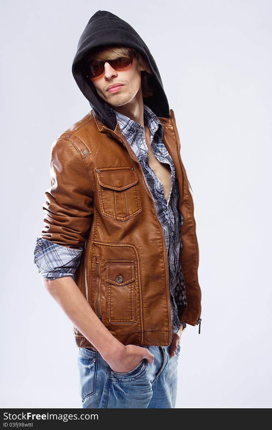 Handsome young man in leather jacket, studio portrait