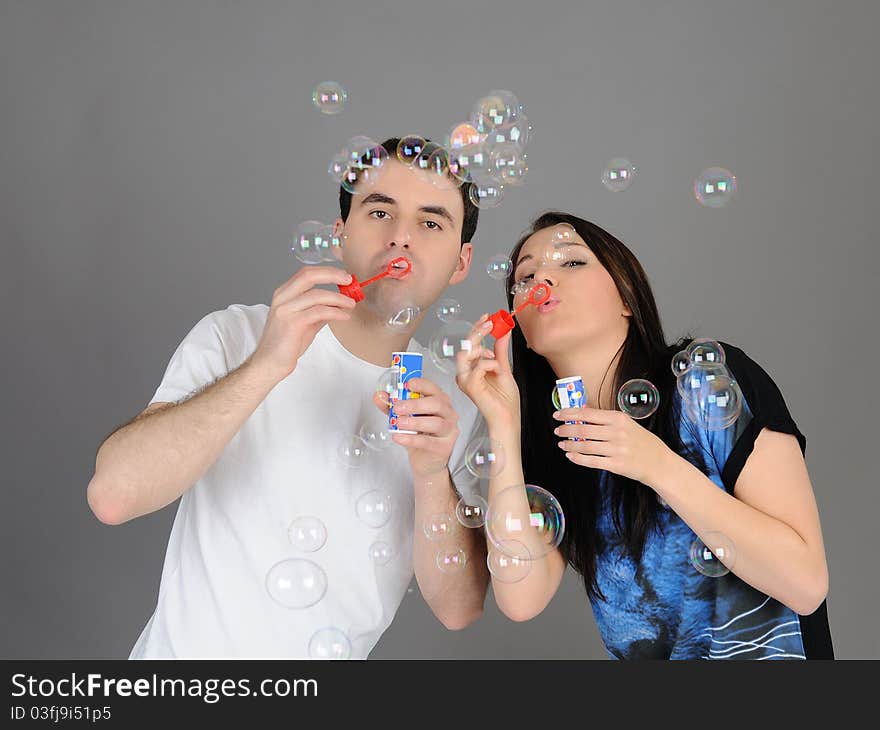 Pretty couple in love blowing bubbles