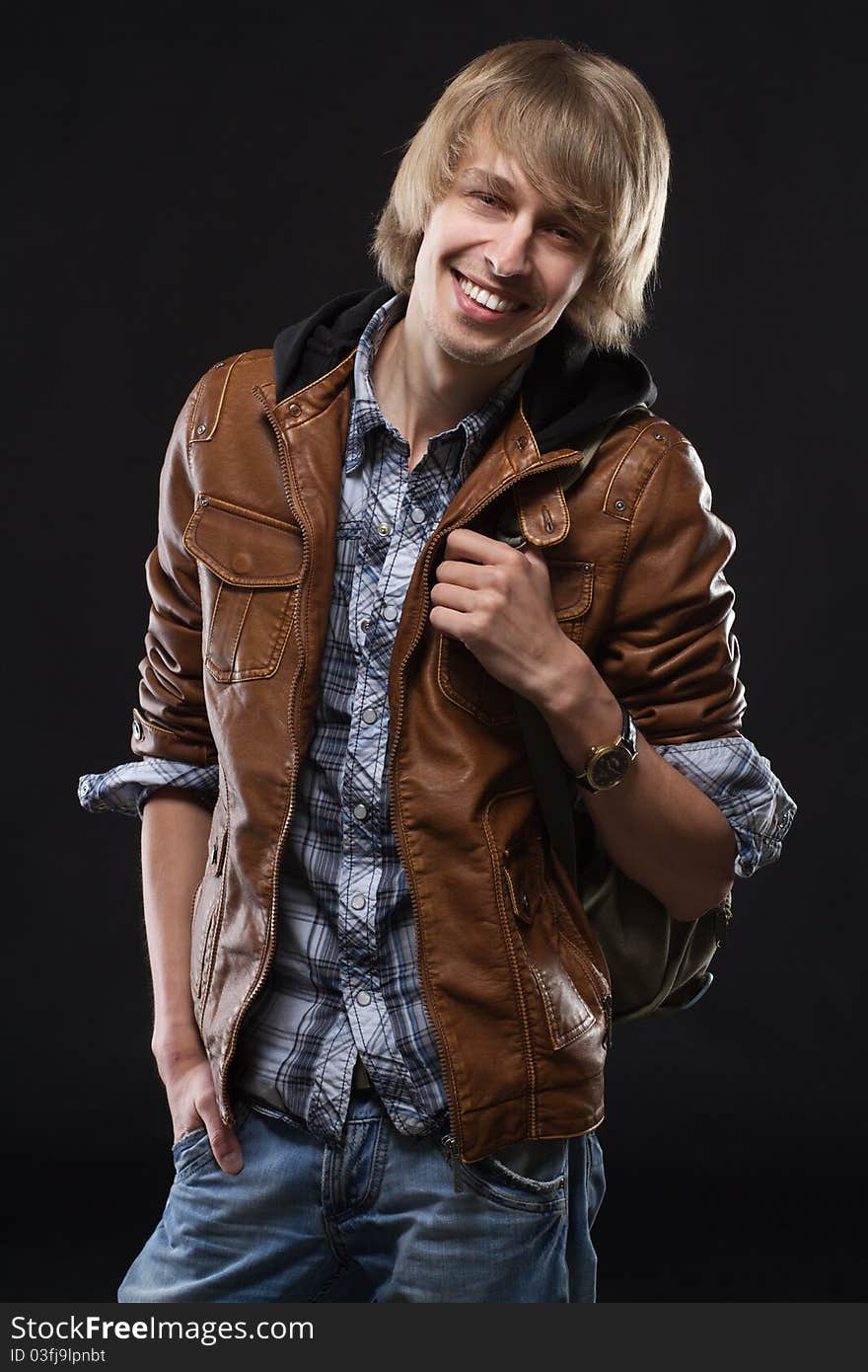 Handsome young man in leather jacket, studio portrait