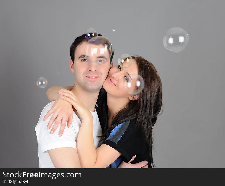 Pretty couple in love blowing bubbles and having fun