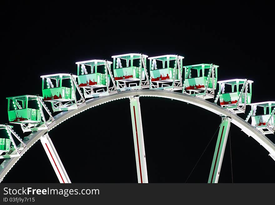 A big colorful ferris wheel at night.