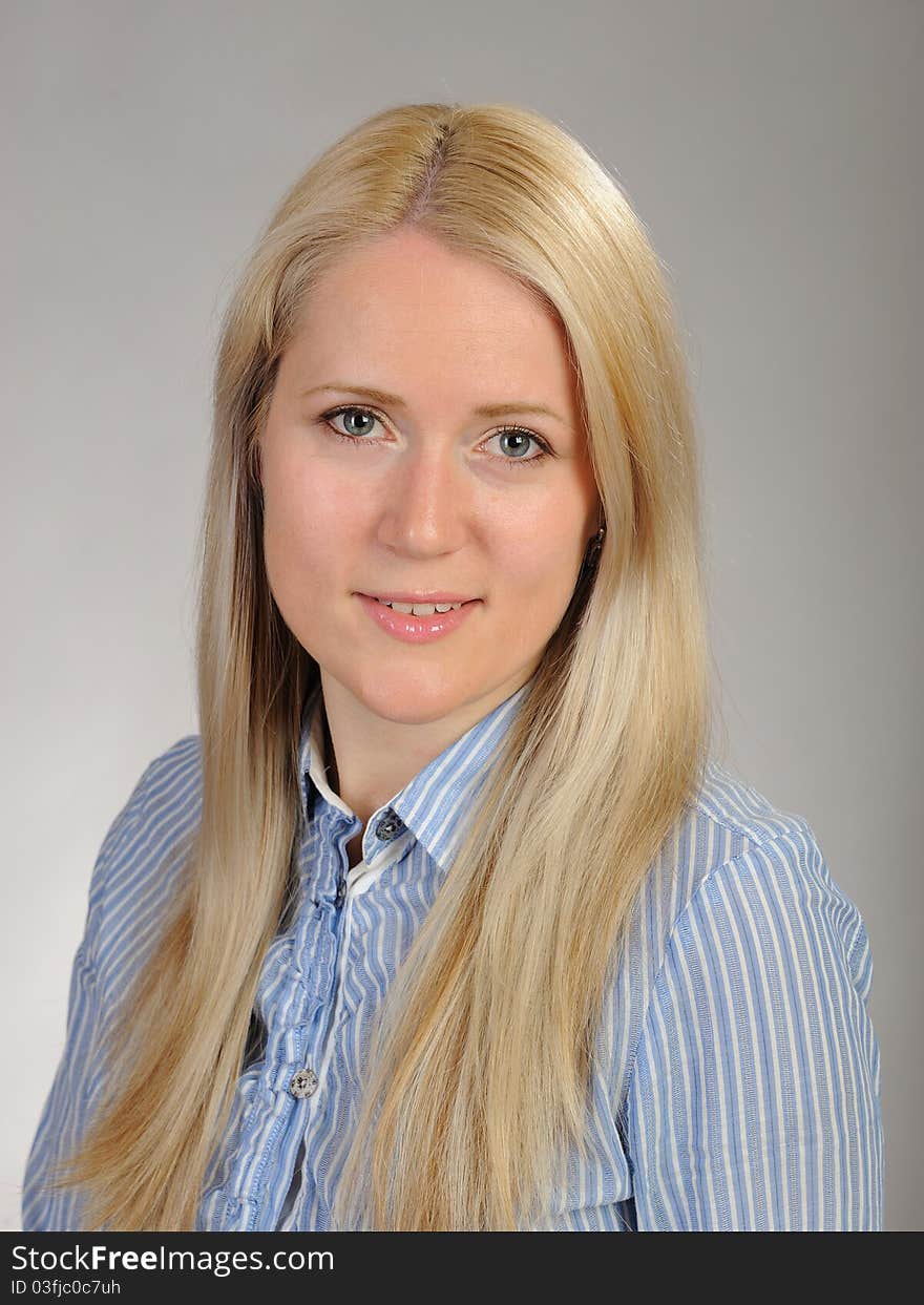 Portrait of young pretty smiling woman in a shirt