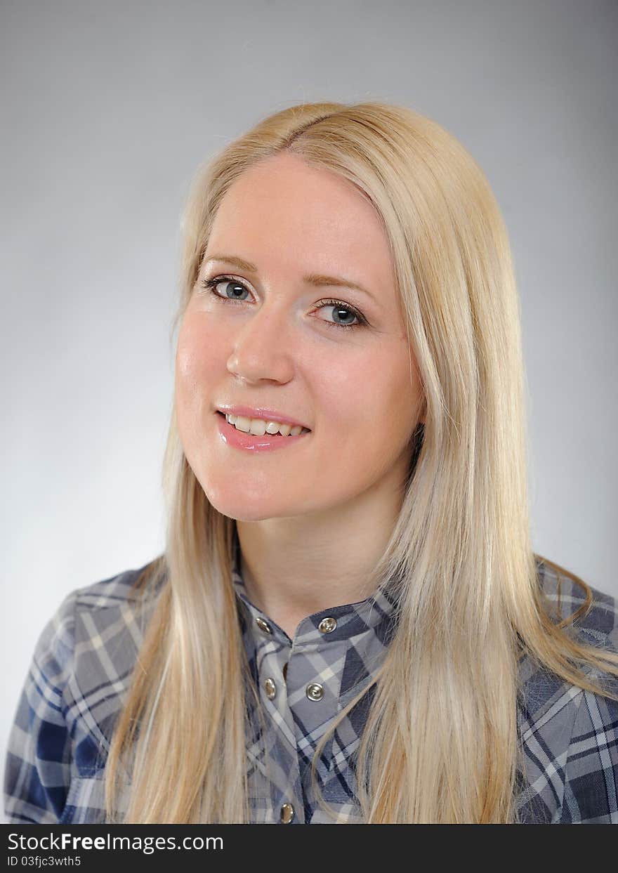 Portrait of young pretty smiling woman in a shirt