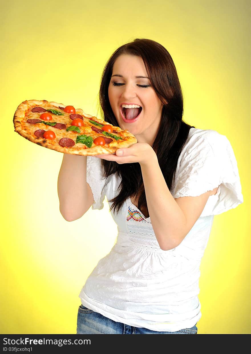 Pretty young casual girl with tasty pizza in delivery paper box. isolated on white background