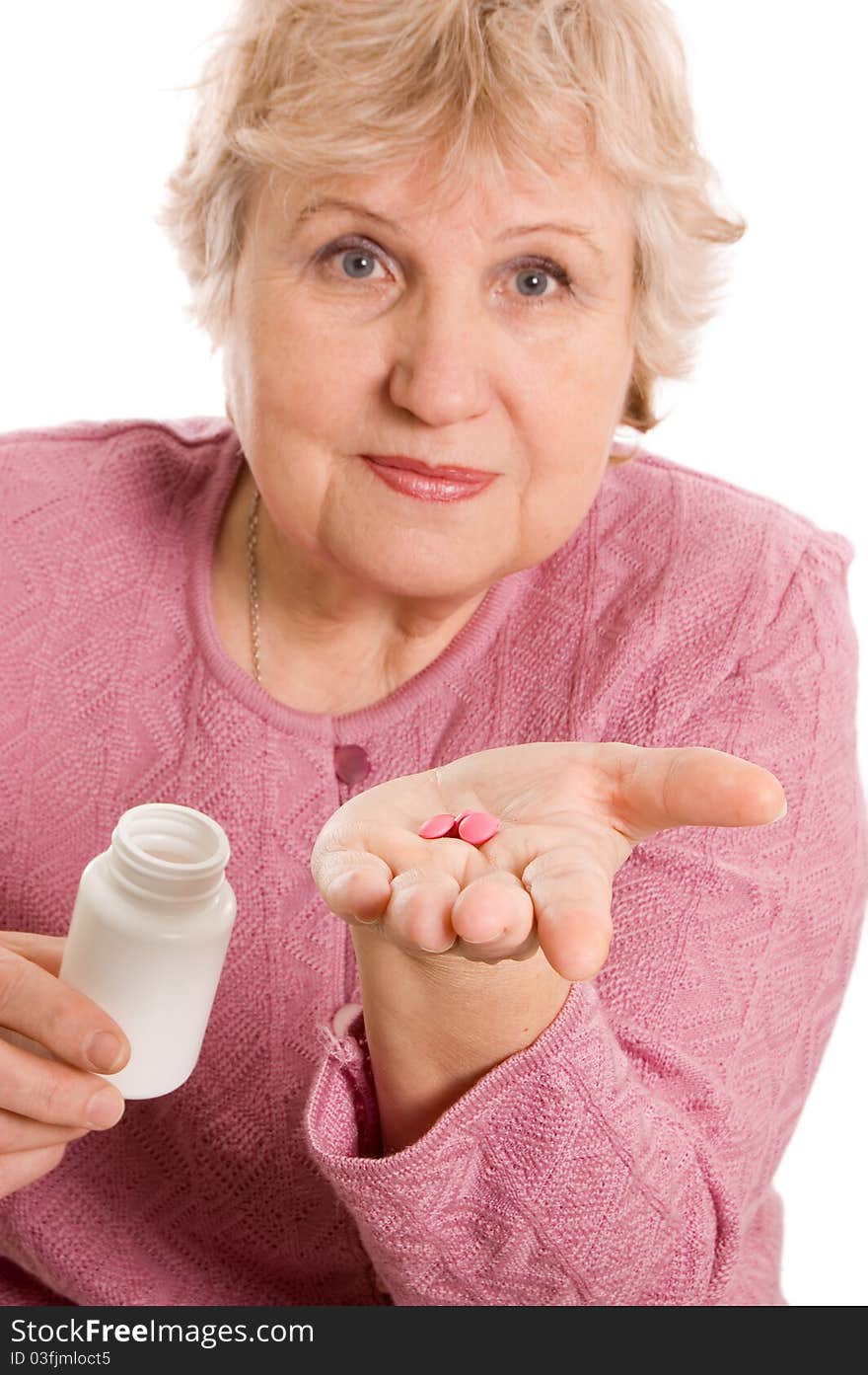 Elderly woman with tablets on white