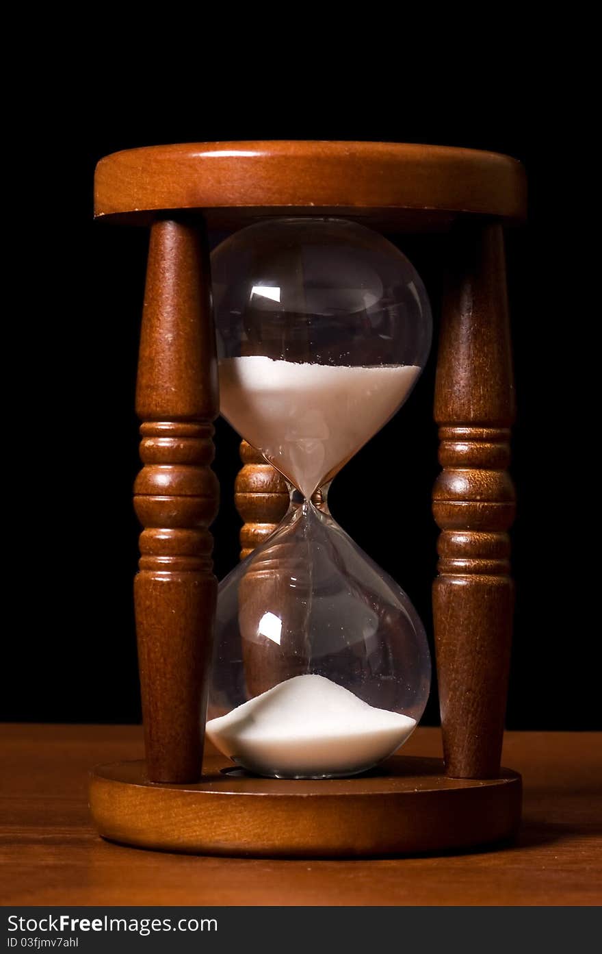 The old hourglasses on a wooden table