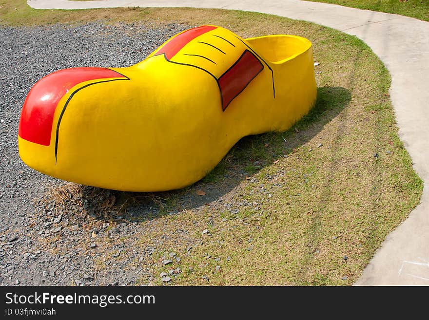 Funny yellow shoe in a park. Funny yellow shoe in a park