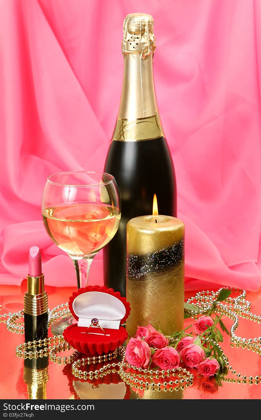 Bottle of a champagne and burning candle. Bottle of a champagne and burning candle