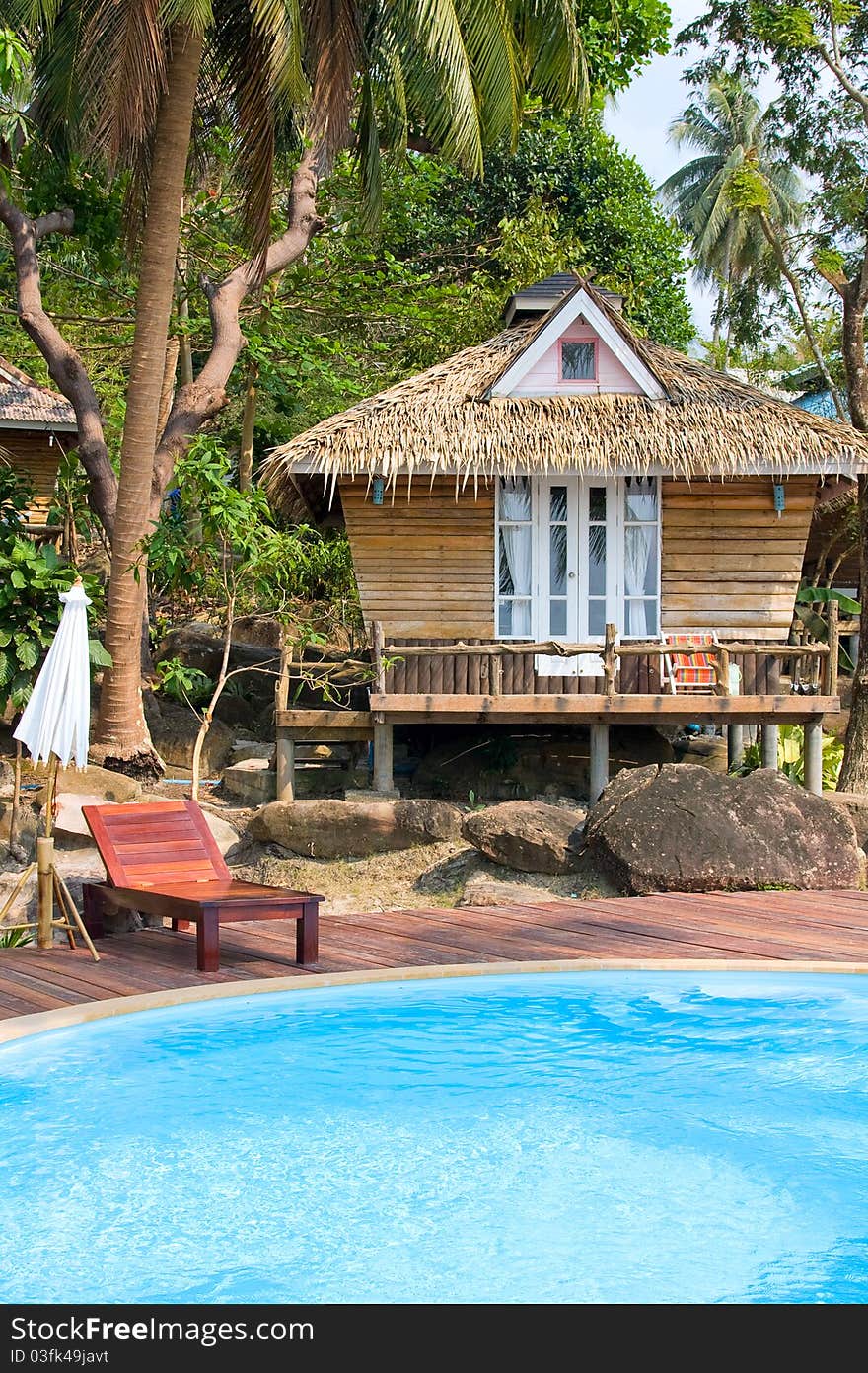 Beach bungalow in tropical Thailand .