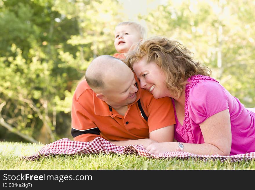 Affectionate Couple with Son in Park