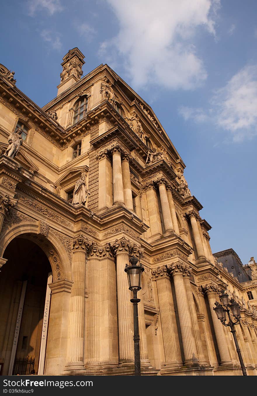 Late afternoon photo of the facade of the Louvre Museum in Paris, France. Late afternoon photo of the facade of the Louvre Museum in Paris, France