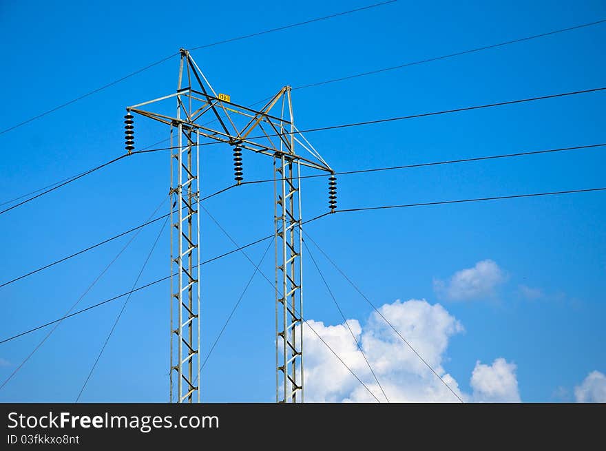 High voltage electricity pylon with blue sky in Thailand.