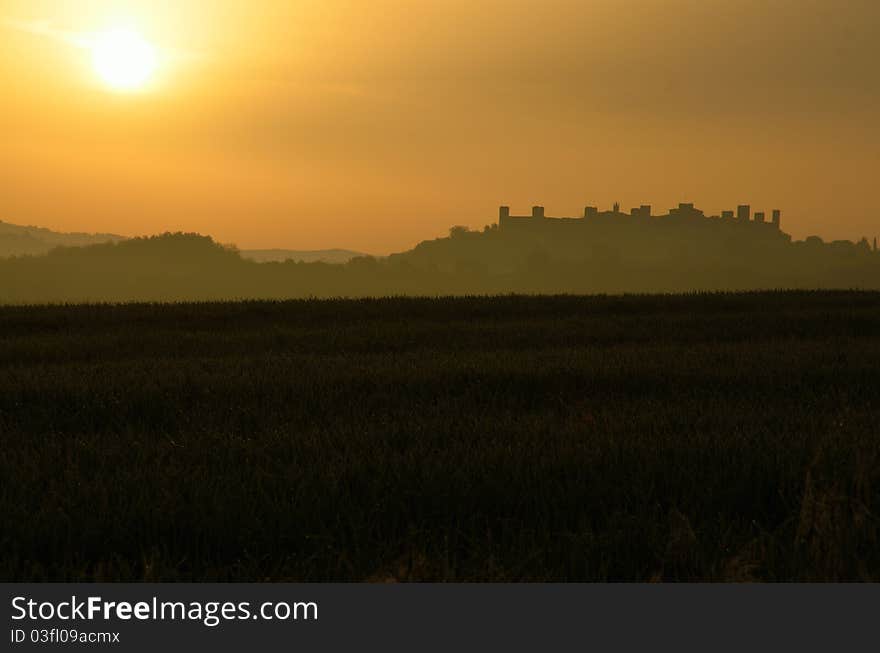 Alandscape with a foggy landscape in a golden light. Alandscape with a foggy landscape in a golden light