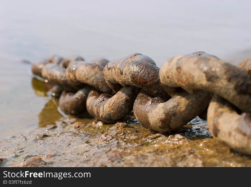 Rusty chain near a water